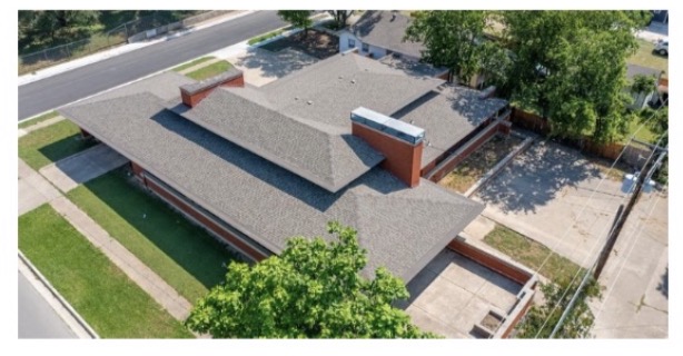 A broader view of the H.E.L.P. residence and surrounding property.